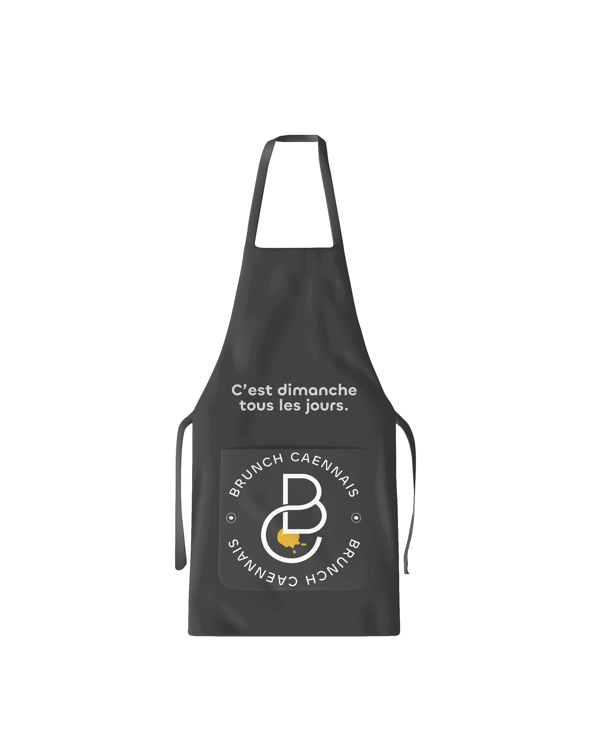 Mockup de tablier noir présentant l’identité visuelle “Brunch Caennais” conçue par Gaële Gerbaux du studio nueva vista : slogan “C’est dimanche tous les jours.” et logo circulaire blanc avec initiales stylisées et pictogramme jaune, imprimés sur la poche avant du tablier.