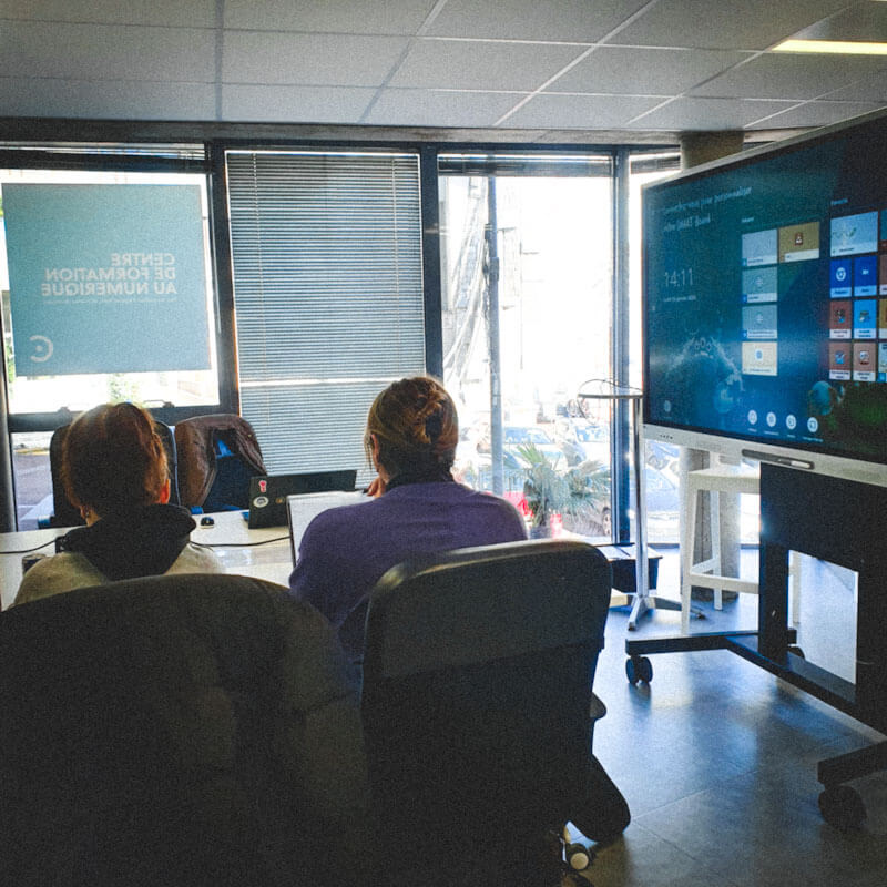 Salle de formation avec des apprenants en design numérique.